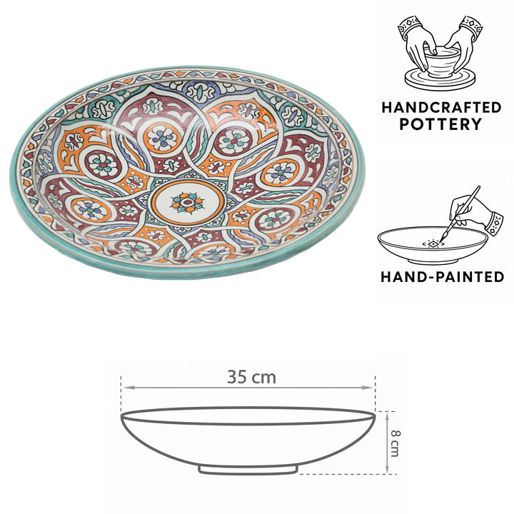 Taça de cerâmica marroquina pintada à mão com motivos circulares em turquesa, laranja e vermelho bordô, com Ø 35 cm e 8 cm de altura